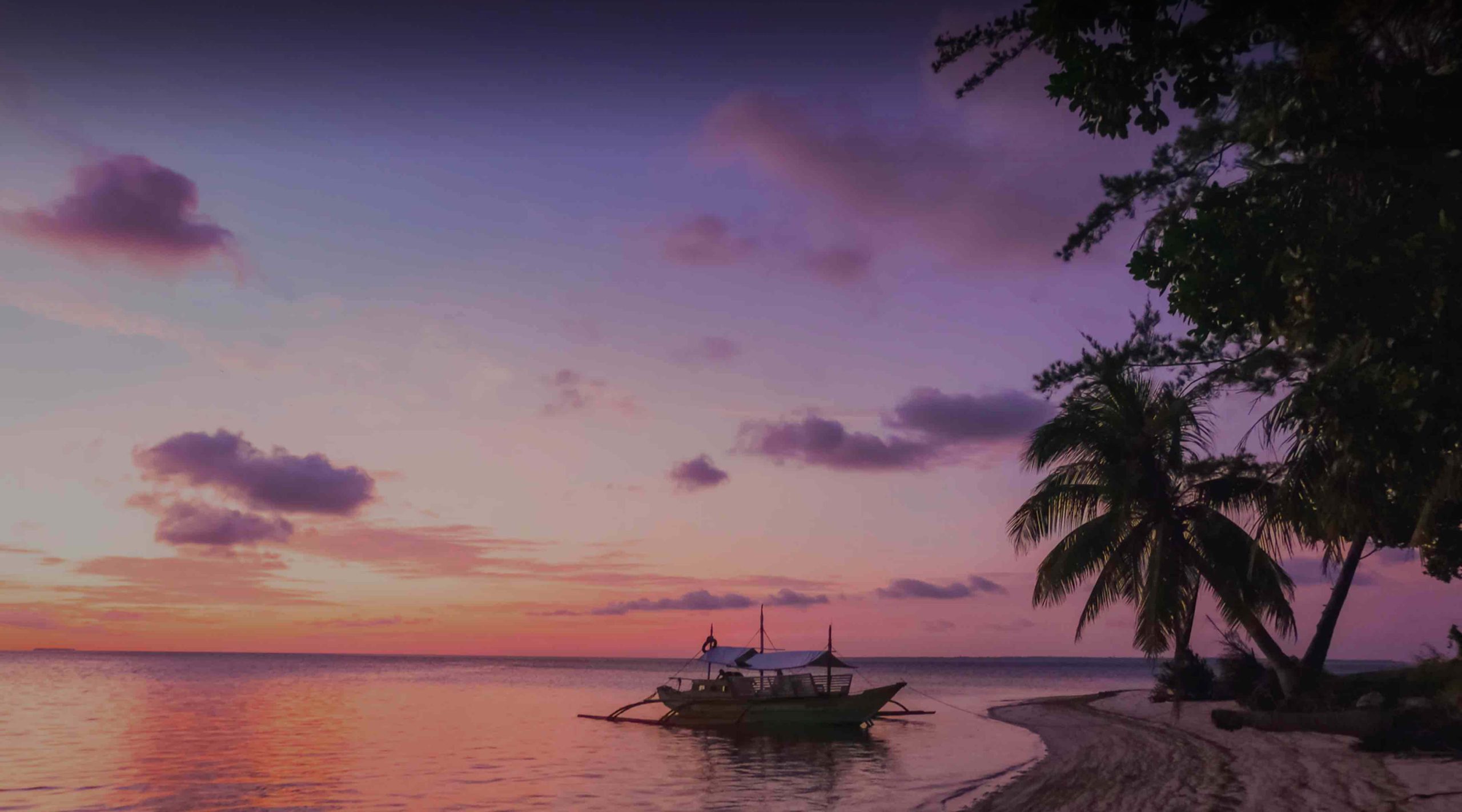 Boat at sunset on Philippines beach